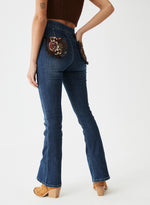 Pantalón denim bolsillos tapicería