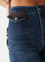 Pantalón denim bolsillos tapicería