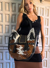 Bolso piel de pelo con tachuelas